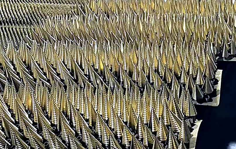 A batch of titanium step drills standing in rows