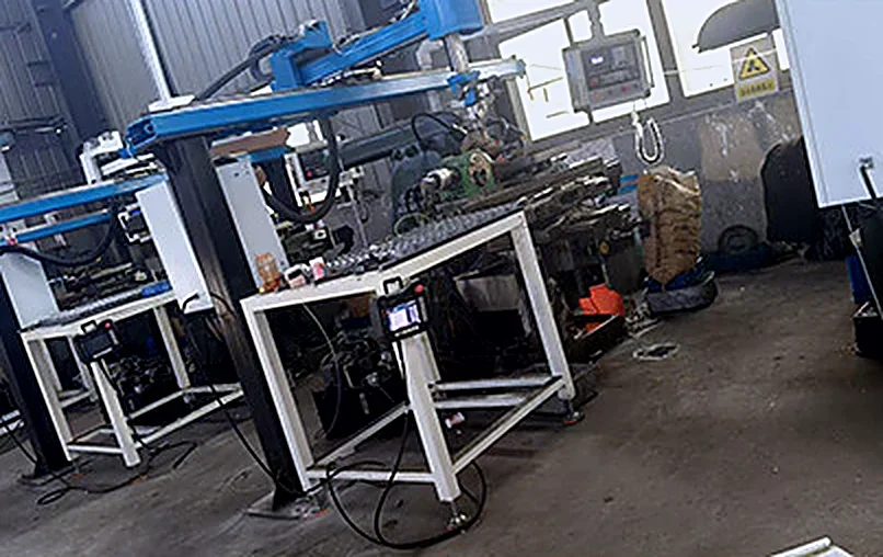 Automatic grinding machines with loading arms and bit feeders