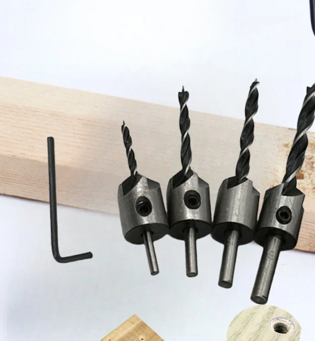 Four adjustable countersink bits with brad-point drills against a pine board