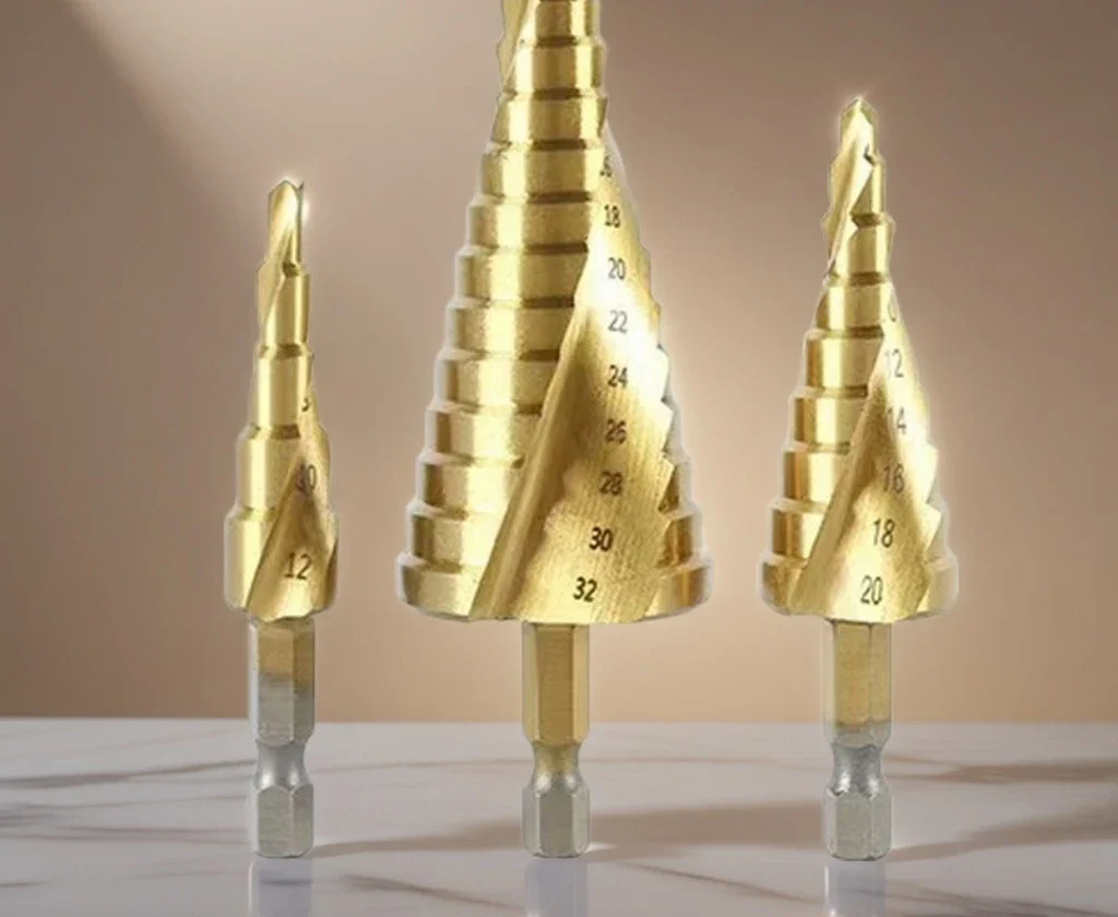 Three titanium spiral-flute step drills with hex shanks
