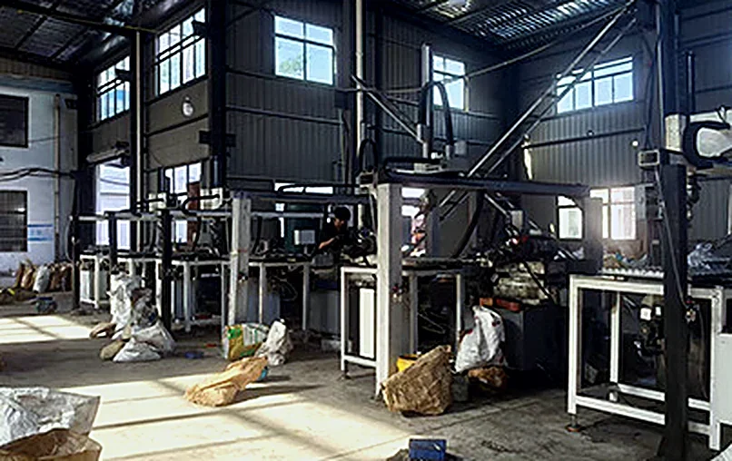 Rows of grinding stations in the drill bit workshop