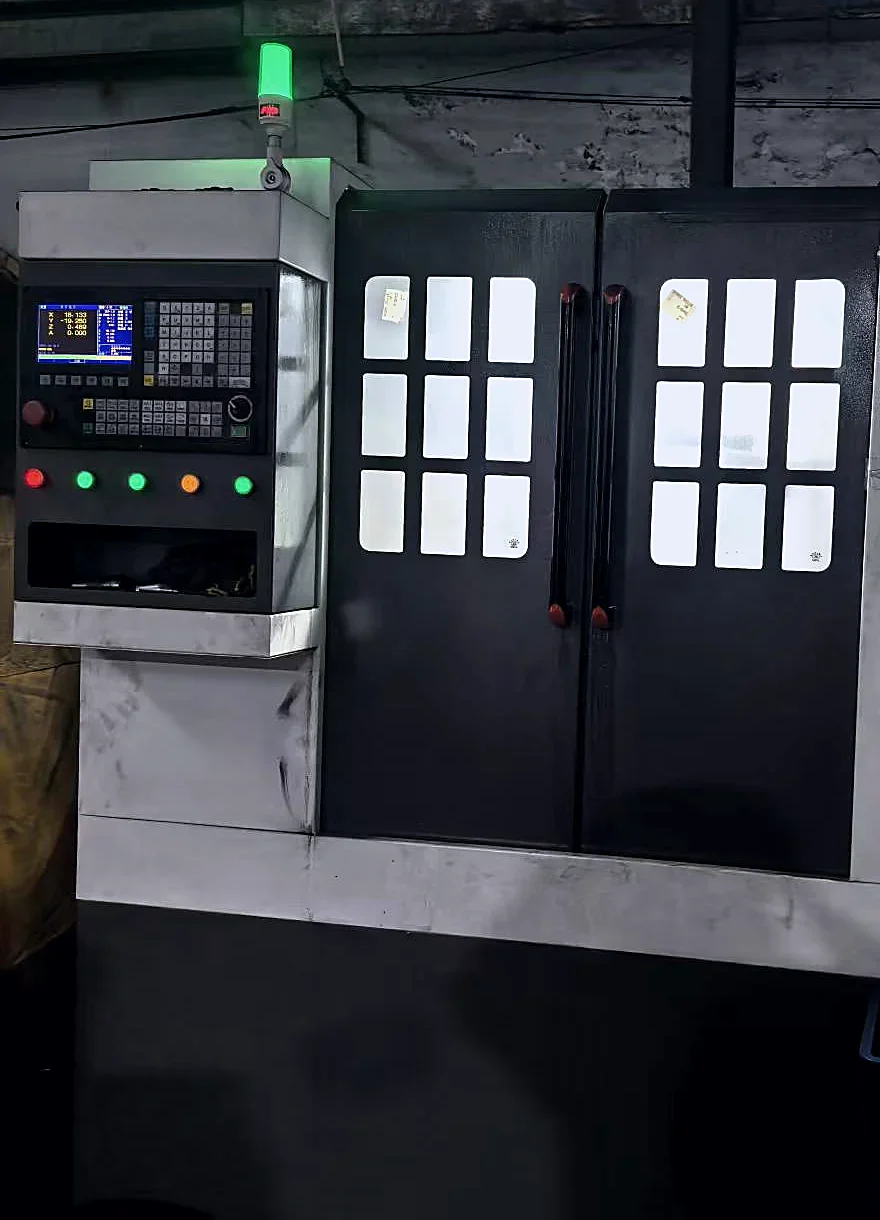 CNC machining center with its control panel in the workshop