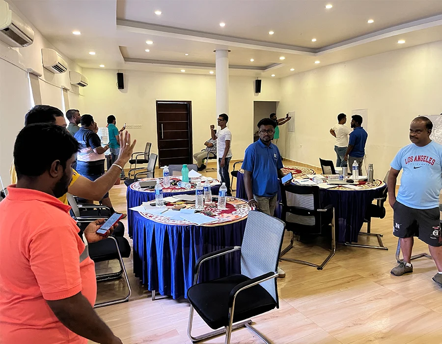 Teams working around tables during a BlueSky Learning simulation