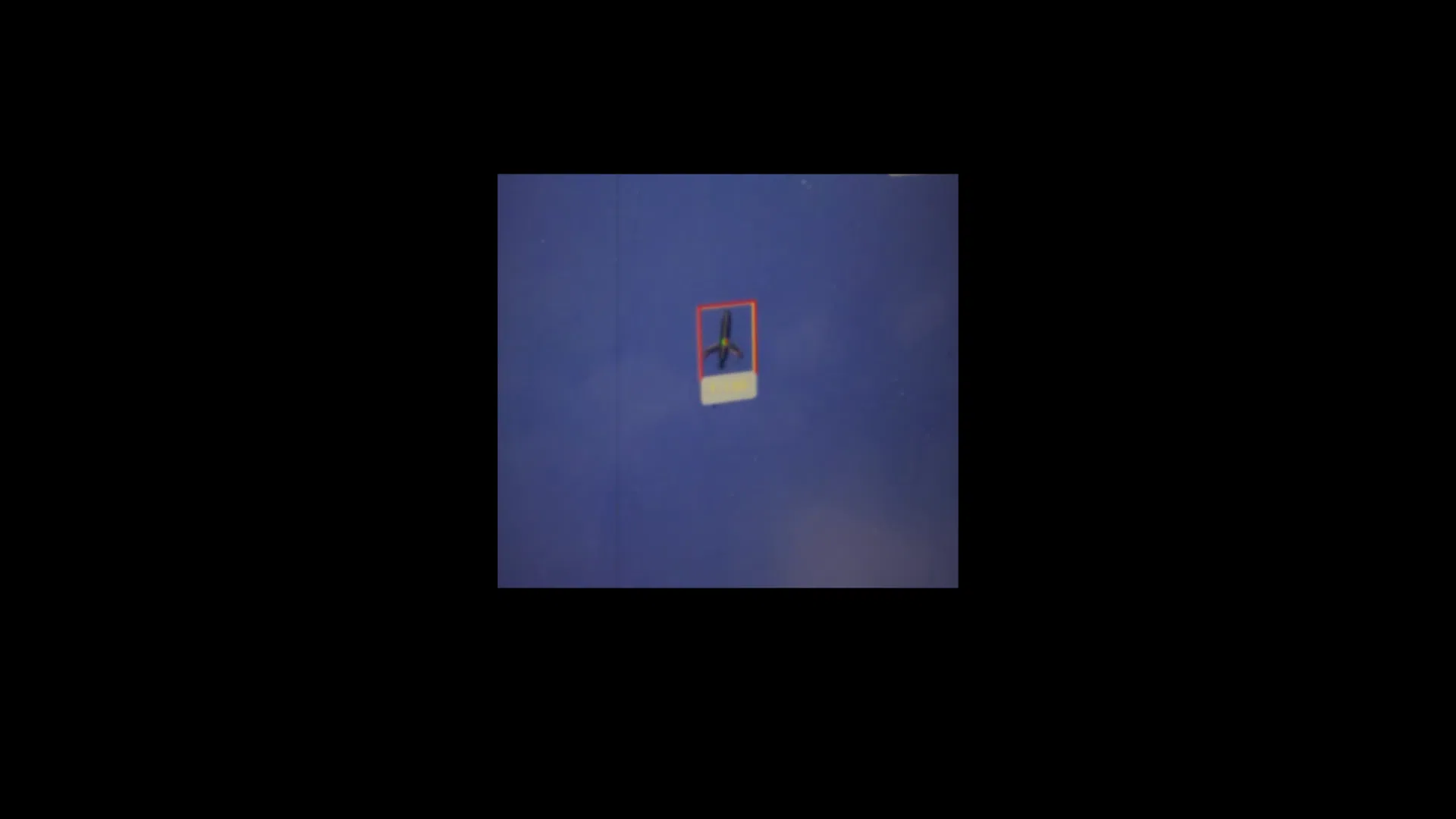 Edda AI point defense turret tracking an incoming FPV drone, with a red bounding box and live telemetry readout overlaid on the target.