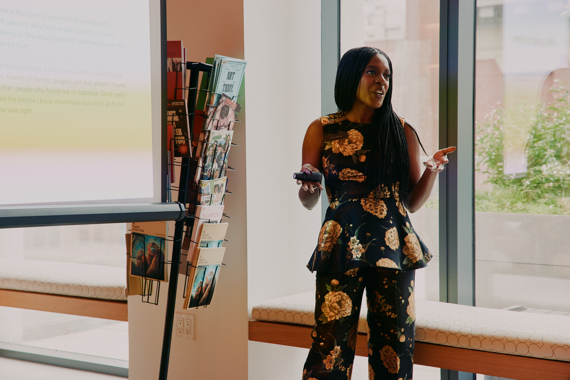 Ashley Rudolph presenting to a group at a workshop, mid-sentence with a warm smile.