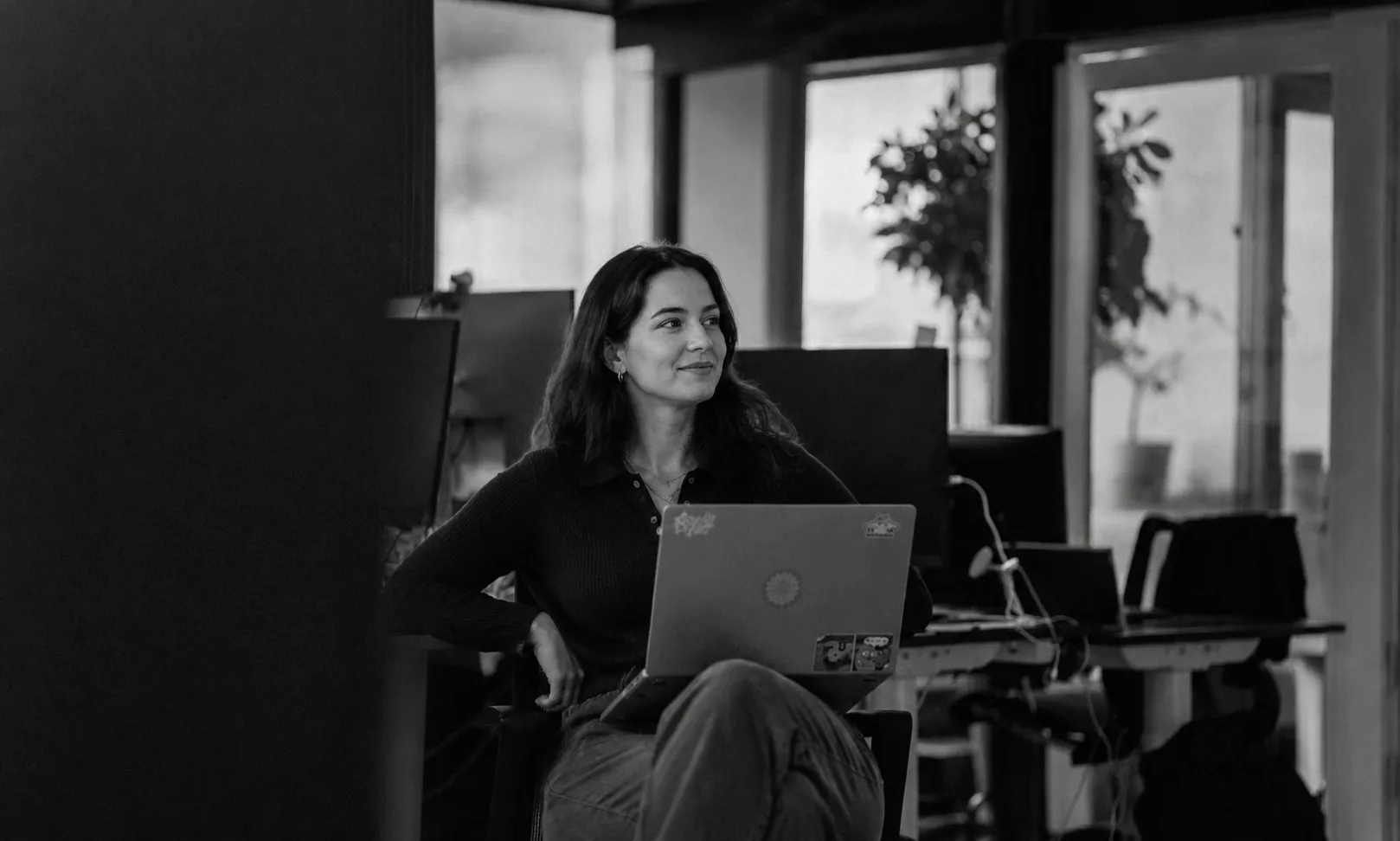 A woman working with a laptop in a modern office