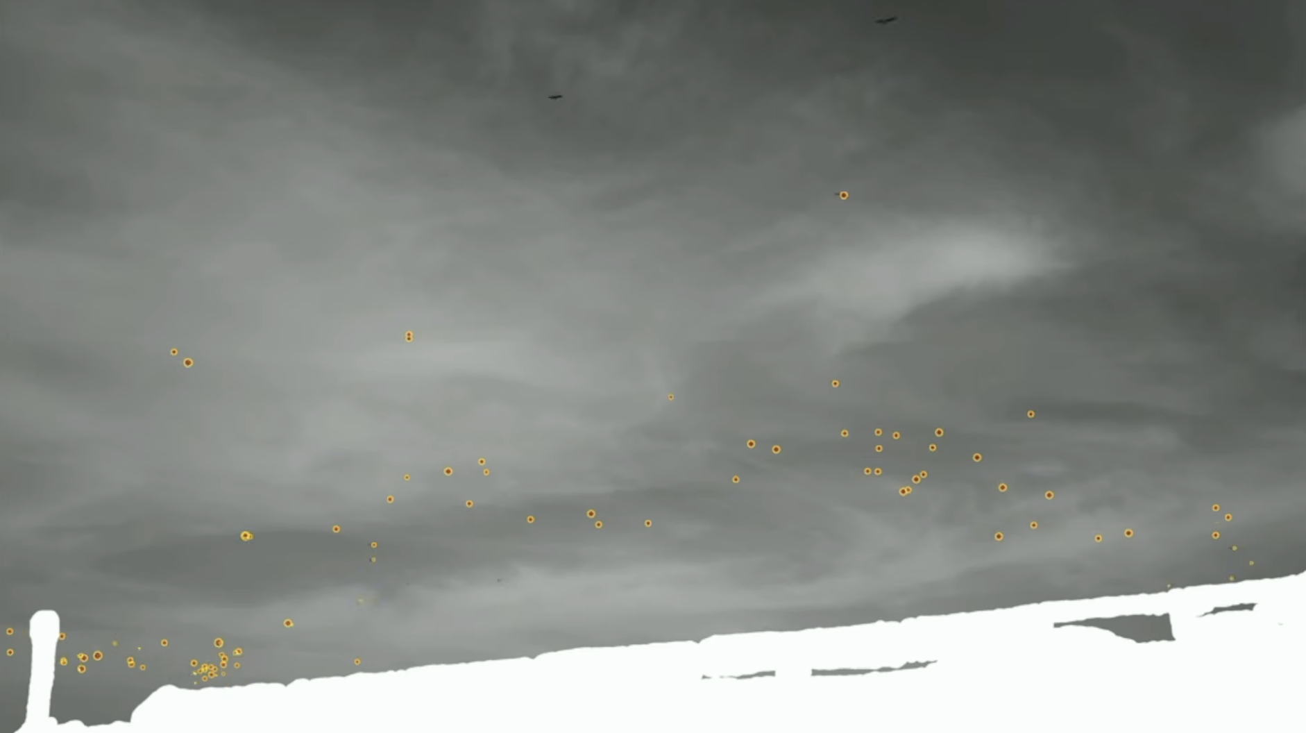 DroneTector detection frame: orange-ringed detections across a cloudy sky