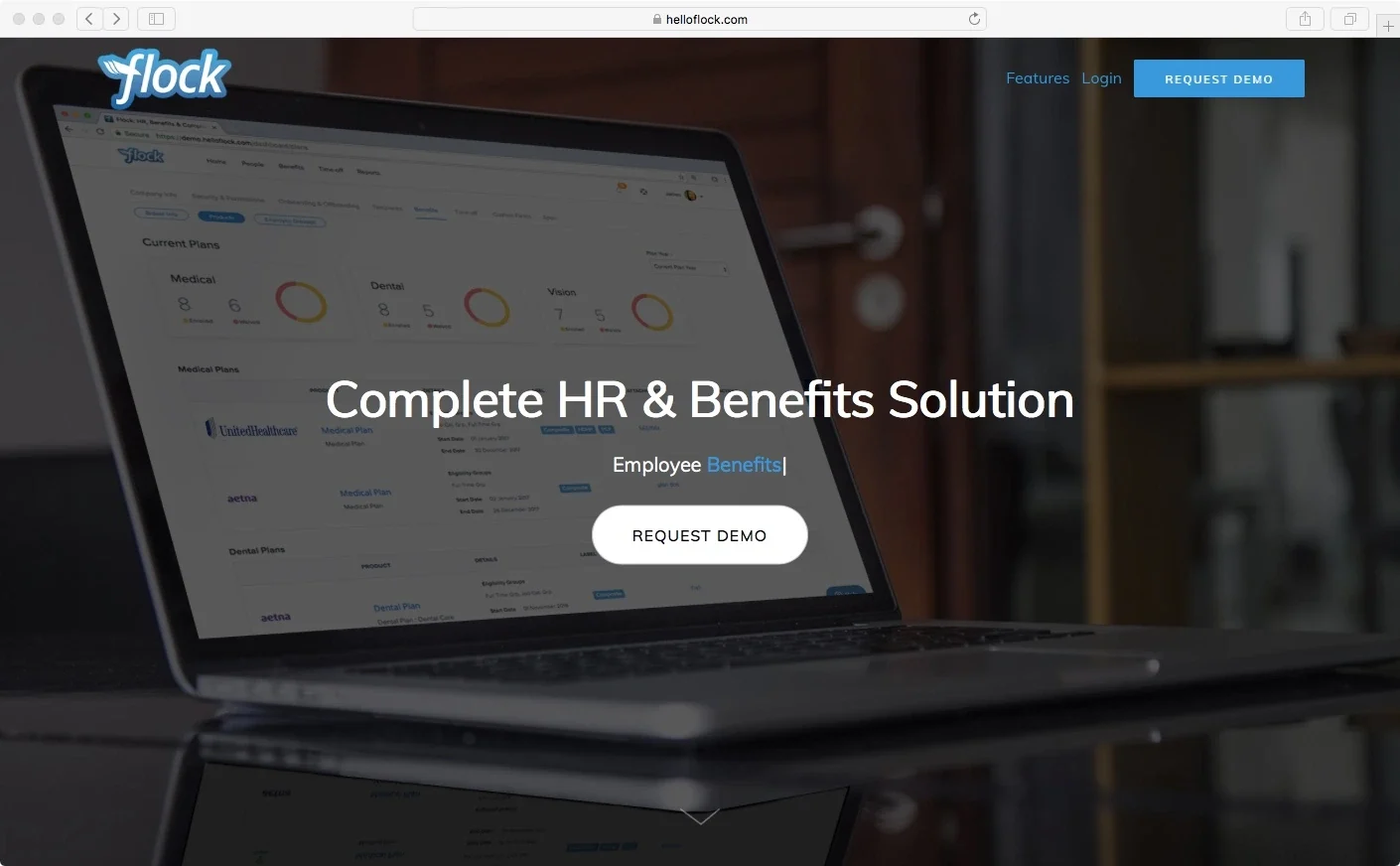 Flock website homepage with an HR and benefits dashboard on a laptop.