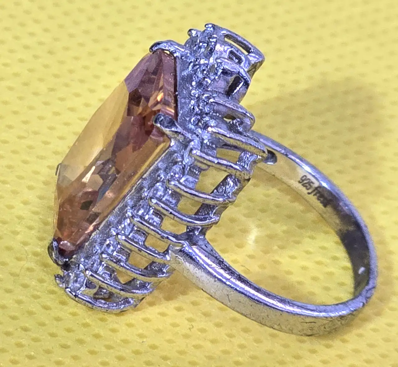 טבעת כסף מרהיבה, משובצת אבן סיטרין כתומה ומסביבה זירקונים.אבני סברוןבסקי חתומה 925. משקל כולל: 8.42 גרם. מידת הטבעת: 7.