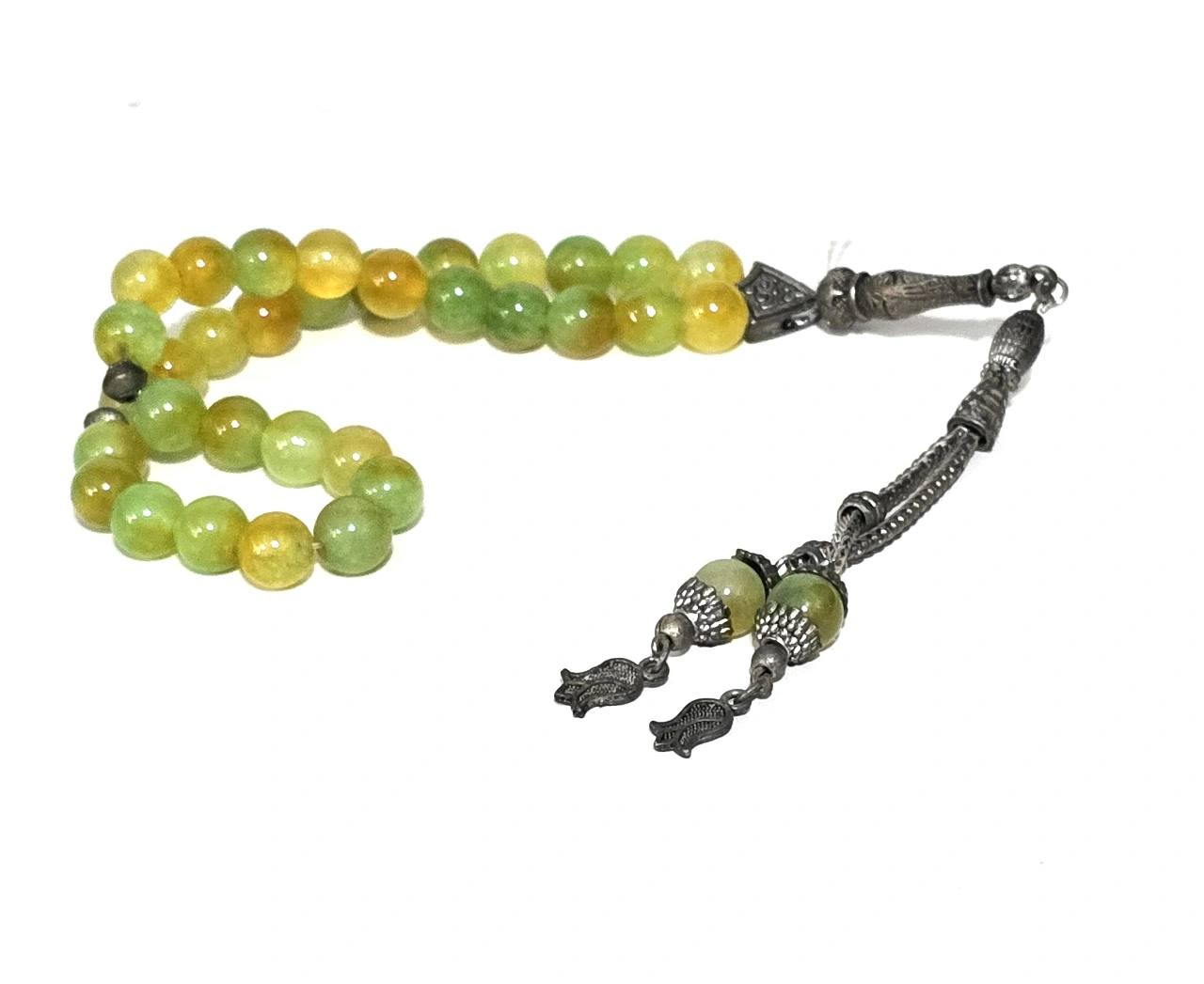 מסבחה תפילה איסלאמית ישנה, מורכבת מ-33 חרוזי זכוכית עגולים בגוונים ירוק-צהוב, משולבת חלקי מתכת בקצה, אורך כולל: 25 ס"מ, קוטר כל חרוז: 6 מ"מ, משקל כולל: 35 גר'.