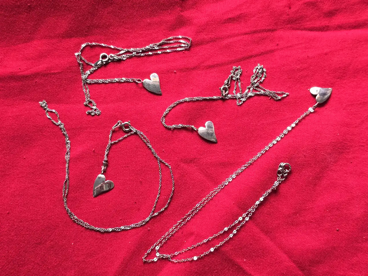 לוט של 4 שרשראות כסף מעוטרות בתליון בדמות לב.  חתומים.  אורך השרשרת 45.5 ס'מ.  משקל כולל 6.8 גרם.