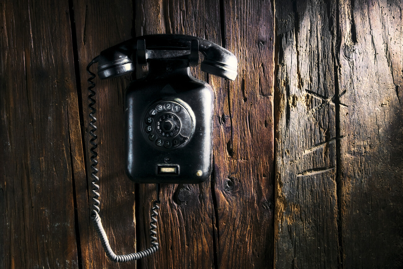 retro telephone an rustic wood wall