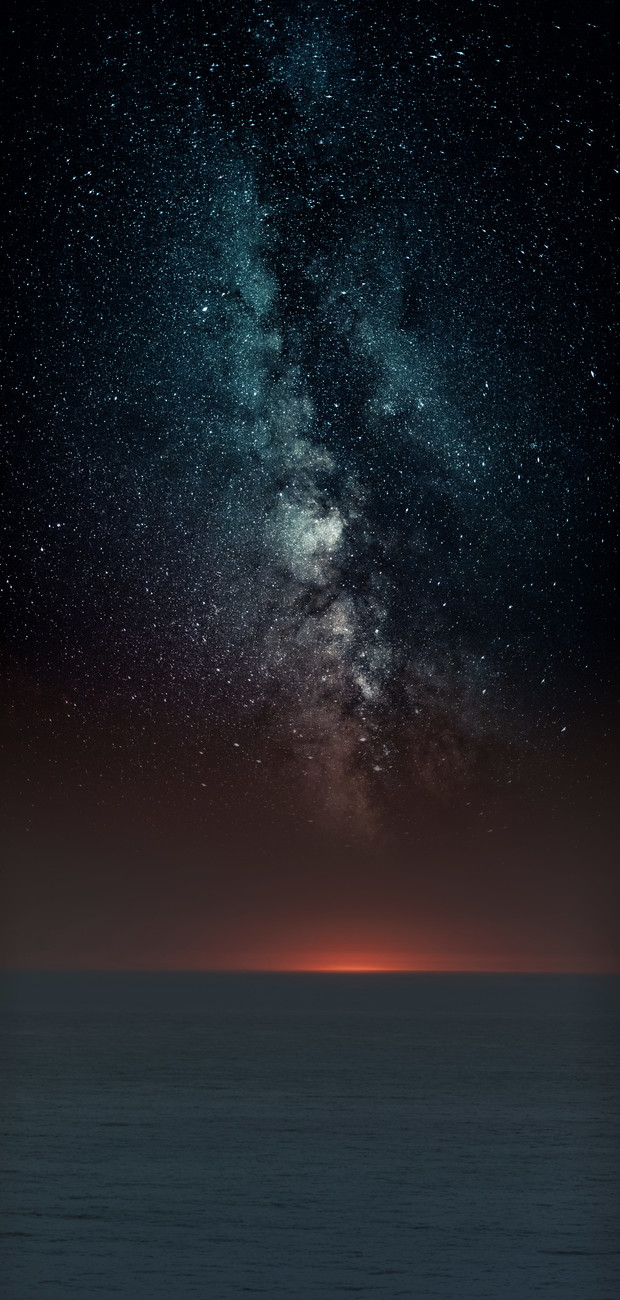 Art Photography Astrophotography picture of sunset sea landscape with milky way on the night sky.