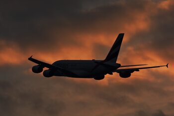 Canvas Print An A380 silhouetted against the evening sky