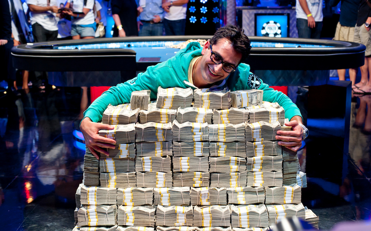 Antonio Esfandiari hugging a stack of $18 million dollars after his Big One for One Drop win in 2012. (Photo: PokerPhotoArchive/Joe Giron)