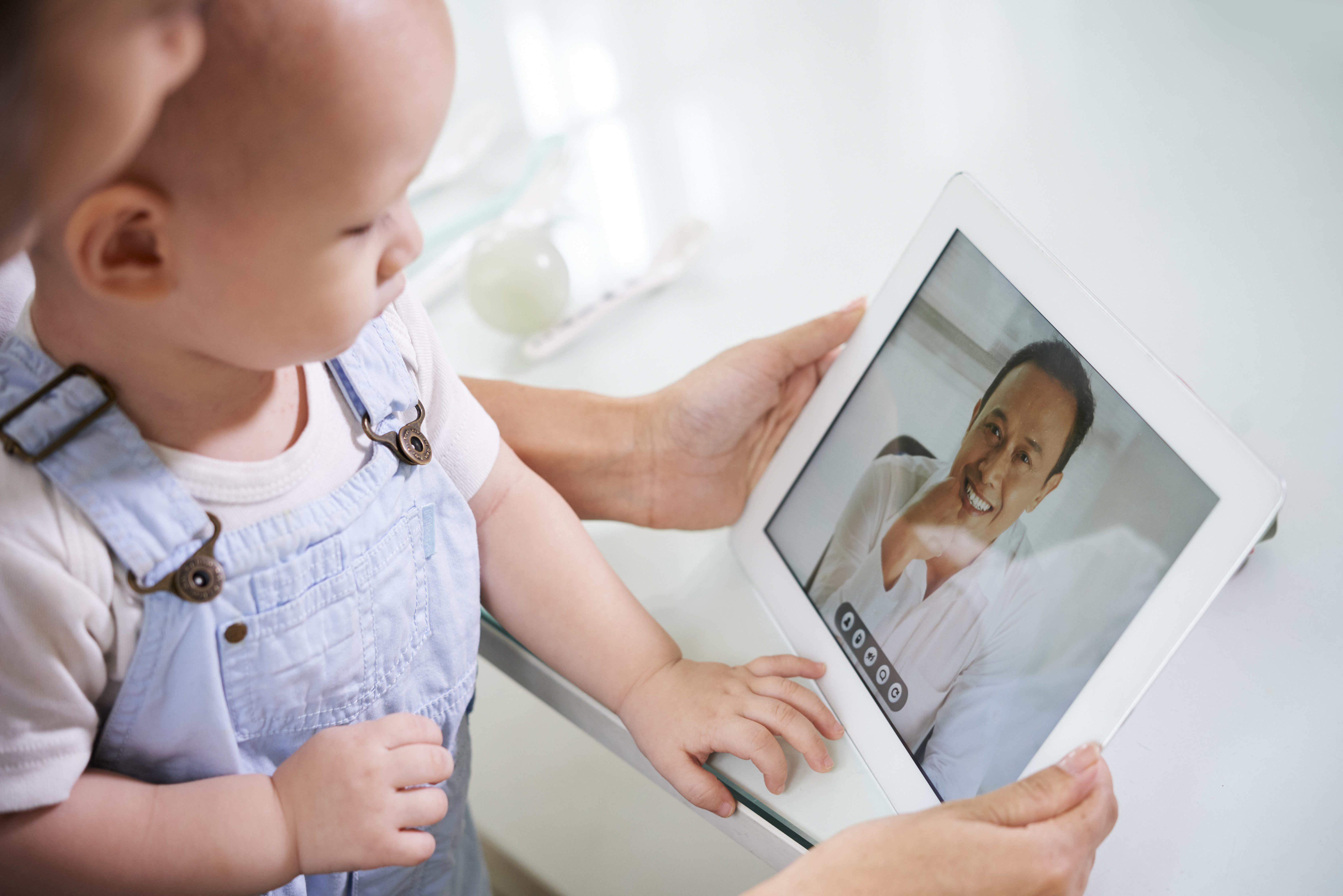 Woman with baby video calling husband