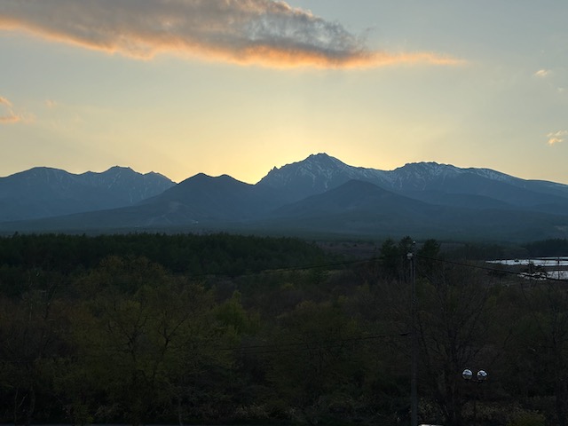 Photo of Yatsugatake Mountains with the sun behind, creating a silhouette.