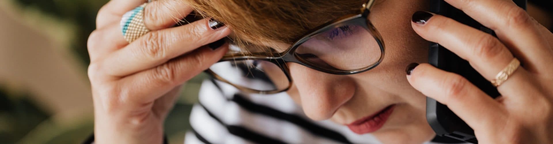 woman worried talking on phone backpayments