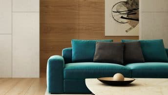 Beautiful blue green couch in a minimalist apartment setting