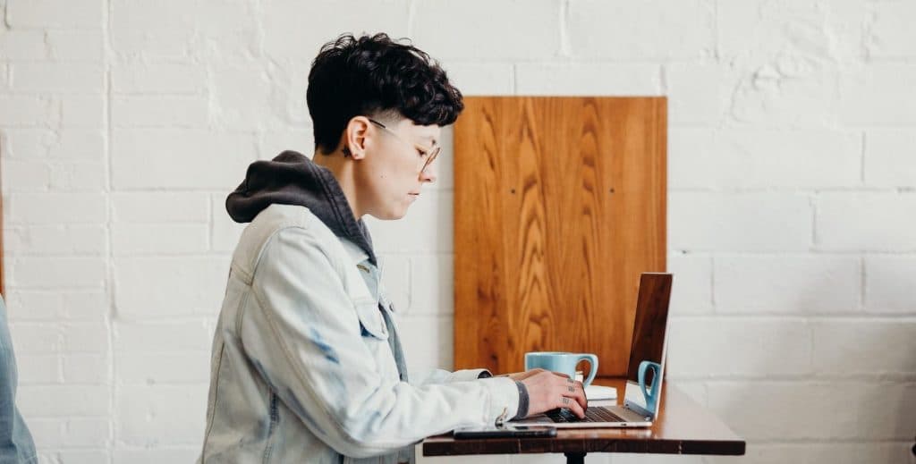 A woman at a cafe working on her computer