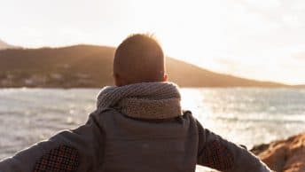 A man with wide open arms enjoying the sun