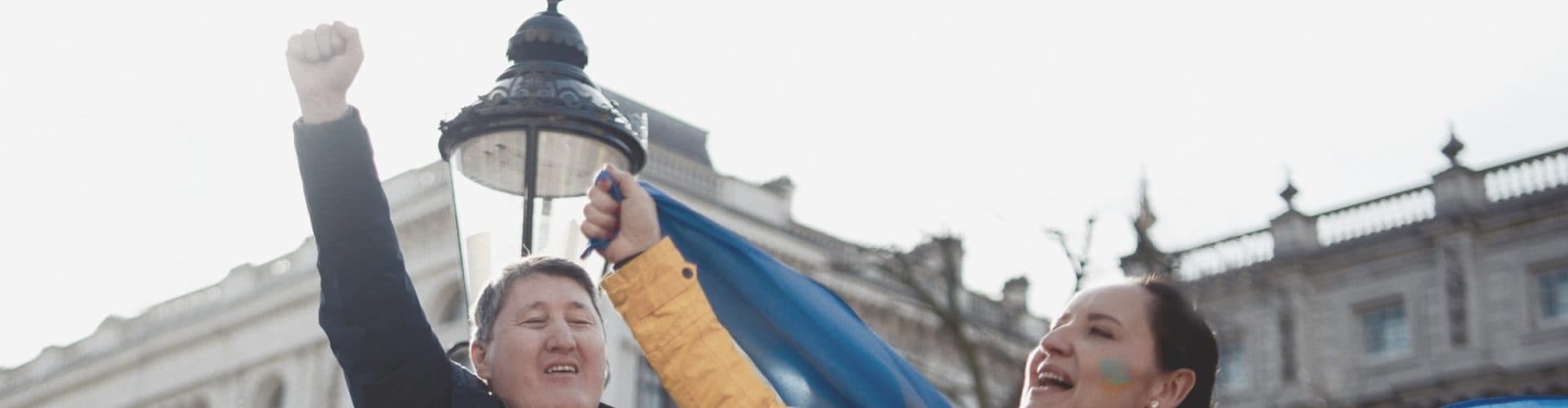 A woman holding the ukrainian flag and protesting