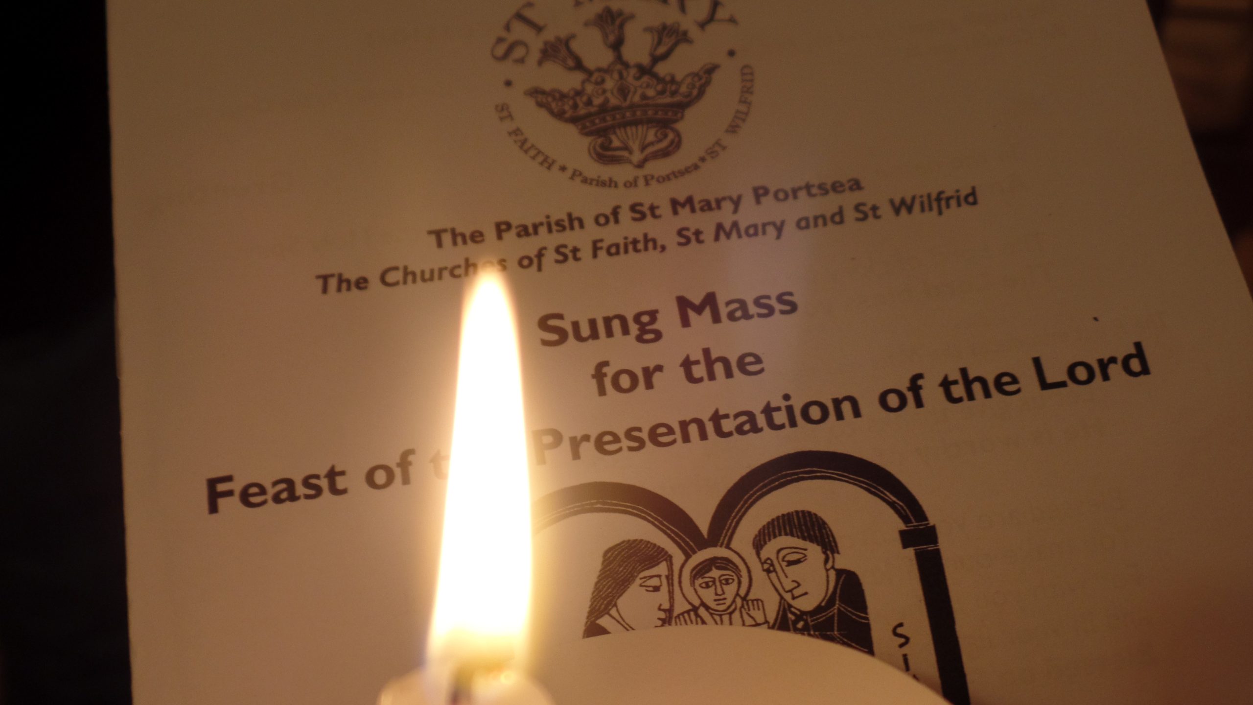 A candle with the Candlemas order of service