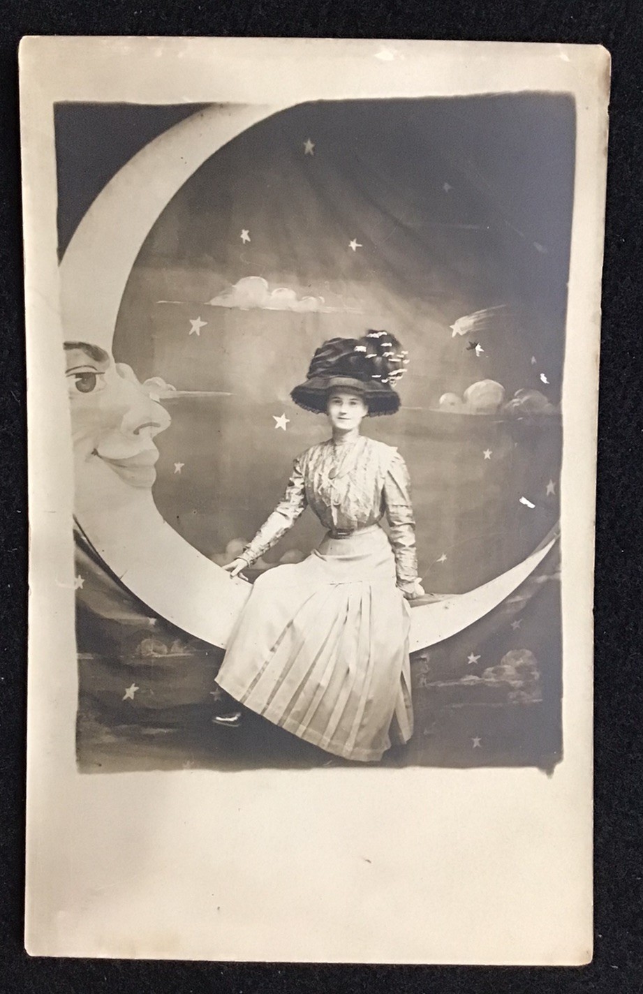 **Input:** ORIGINAL RPPC REAL PHOTO PAPER MOON POSTCARD WOMAN IN LARGE HAT, CLOUDS, STARS

**Output:** Paper Moon, Woman In Large Hat, Clouds, Stars Real Photo Postcard