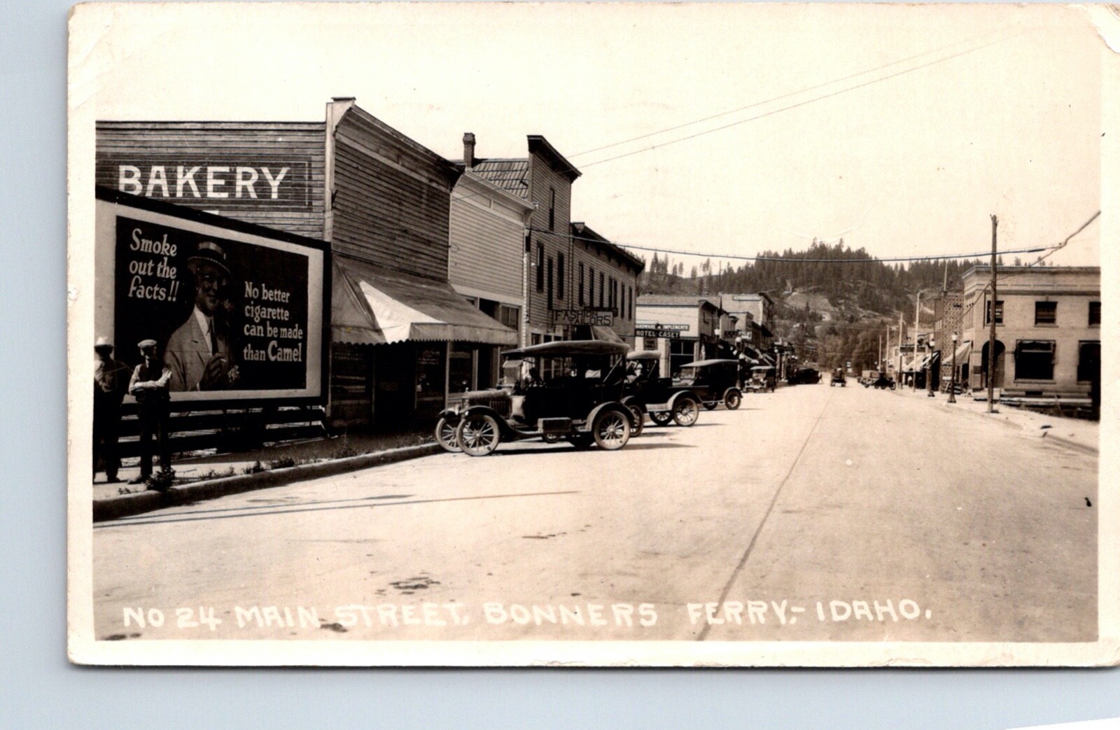 Bonners Ferry Idaho Main Street With Camel Billboard And Car Real Photo Postcard