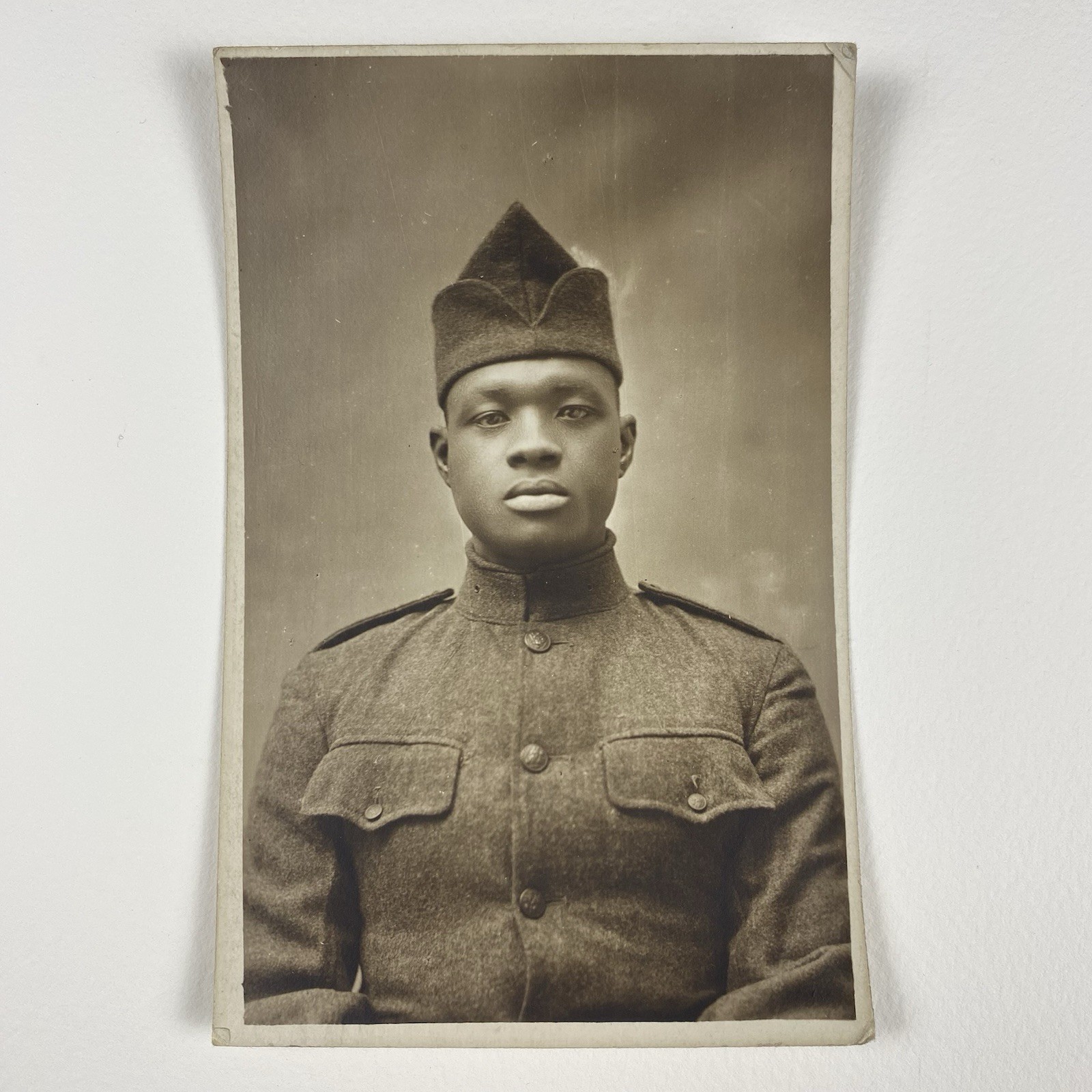 **Original title:** WW1 Black Soldier RPPC Uniform Handsome Clean Shaved Real Photo Post Card

**Rewritten Title:** World War 1 Clean Shaved Black Soldier Uniform Real Photo Postcard