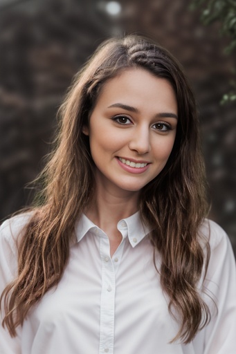 Woman in white button up shirt models for headshot photo