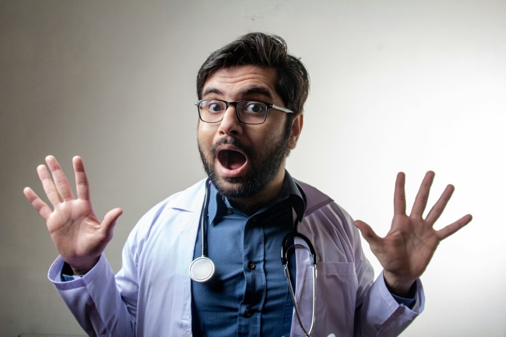 Doctor posing for awkward headshot photo