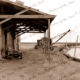 Small boats & wharves, Port Wakefield, SA. c1950s. Crane