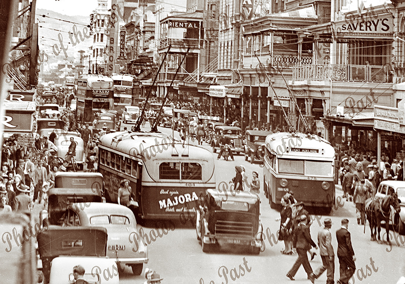 View down crowded Rundle St, Adelaide. S.A. with trolly buses & a horse, c1940.