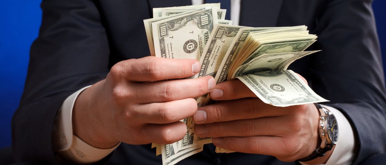 Businessman counting 100s