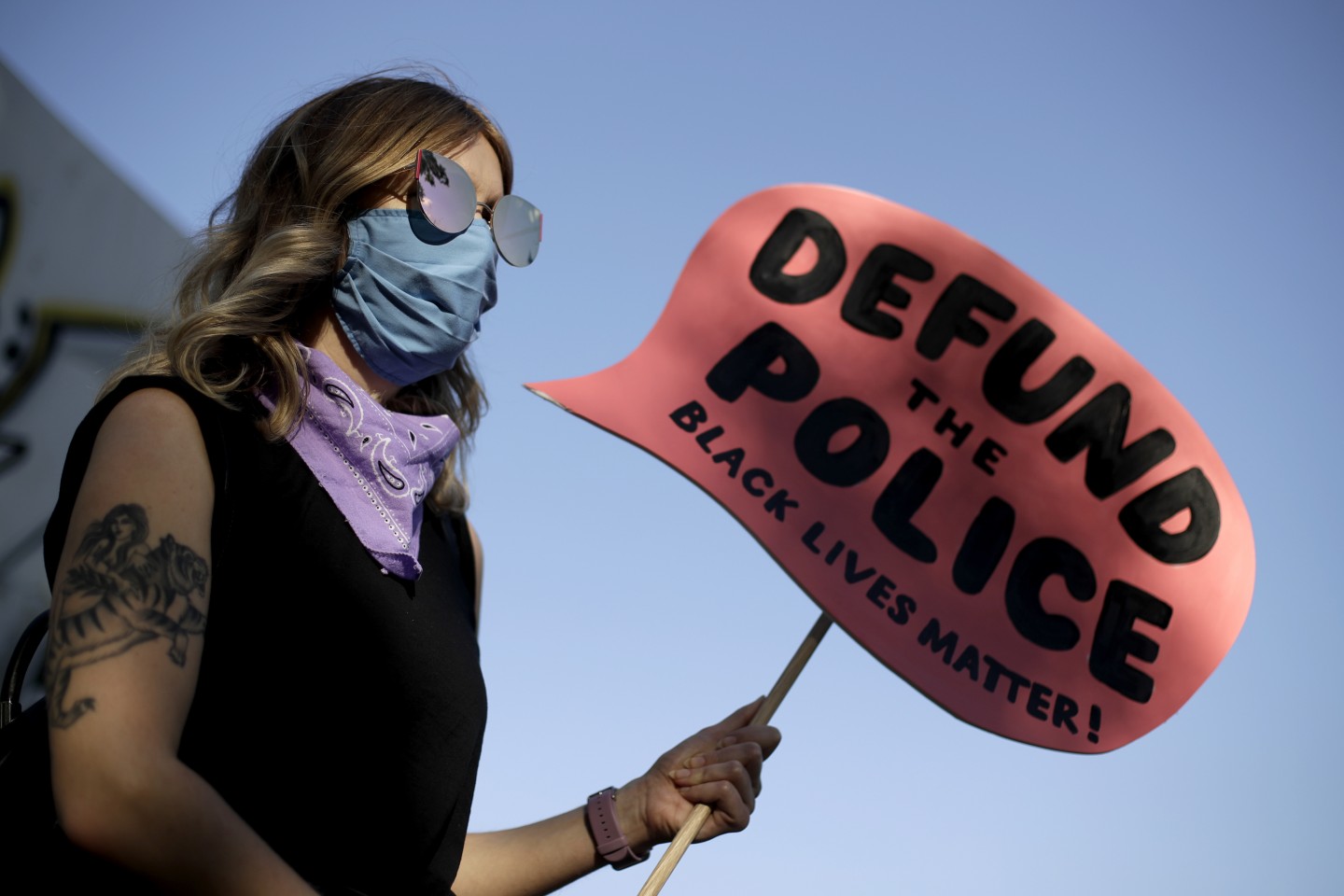 Protester w defund police blm sign