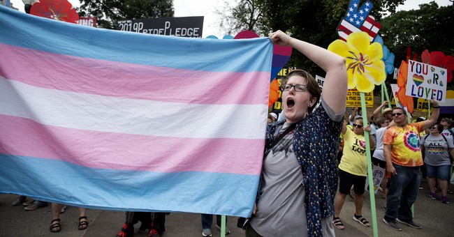Protester waving transgender flag
