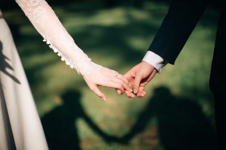 Bride groom holding hands