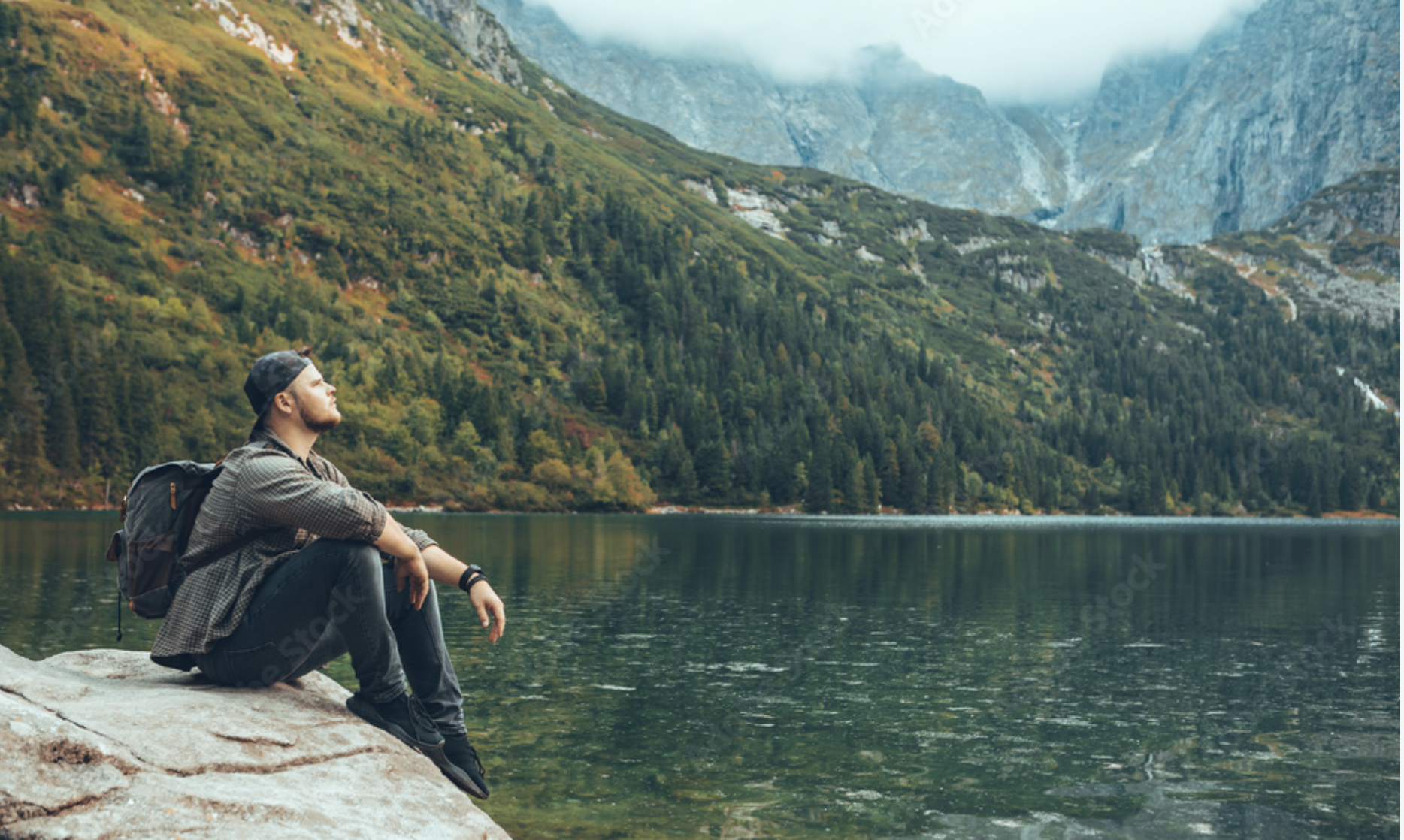 Man sitting mountains lake