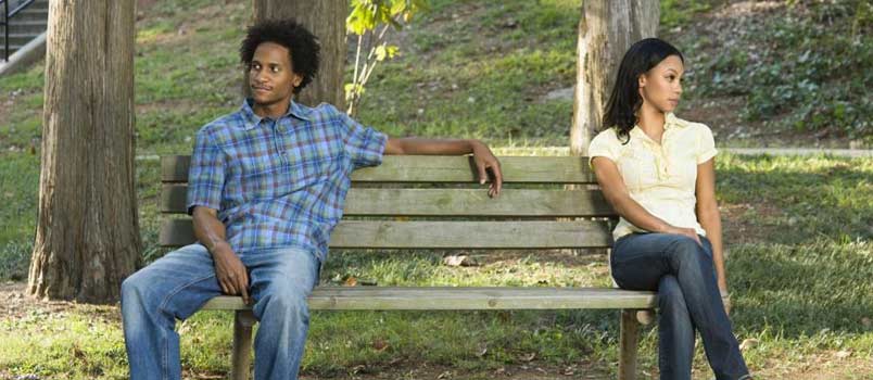 Couple separated park bench