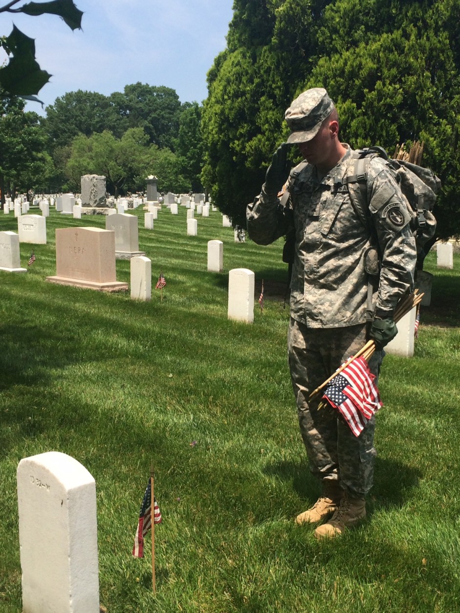 Soldier salutes memorial day flag