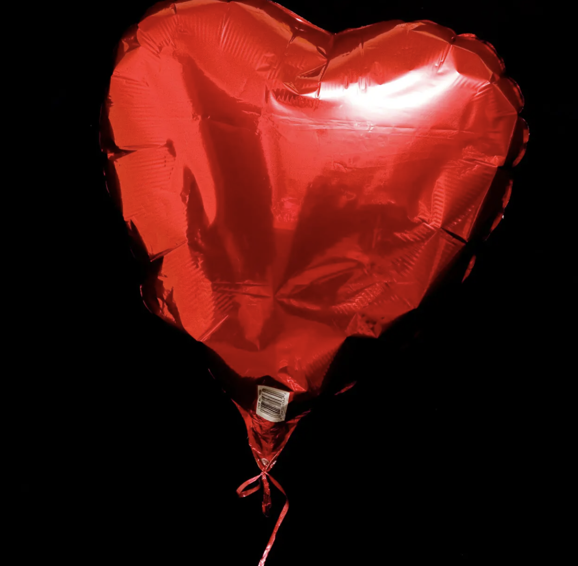 Deflating red heart balloon