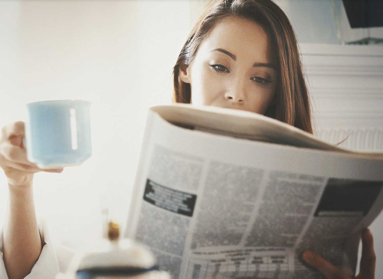 Woman reading newspaper