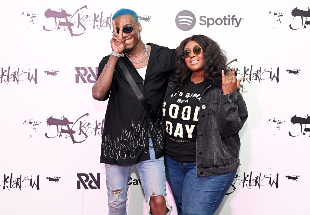 Langston Bleu and Brittney Spencer posing in front of a Spotify x Rap Caviar step-and-repeat.