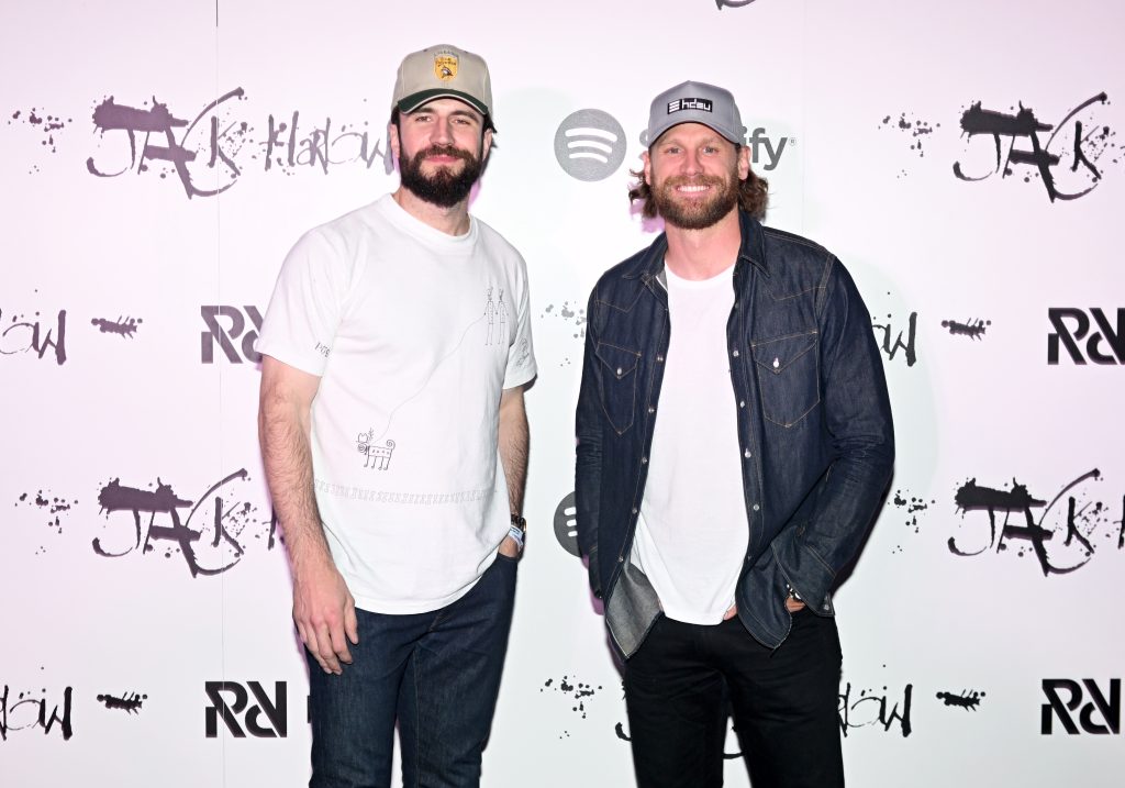 Sam Hunt and Chase Rice posing in front of a Spotify x Rap Caviar step-and-repeat.