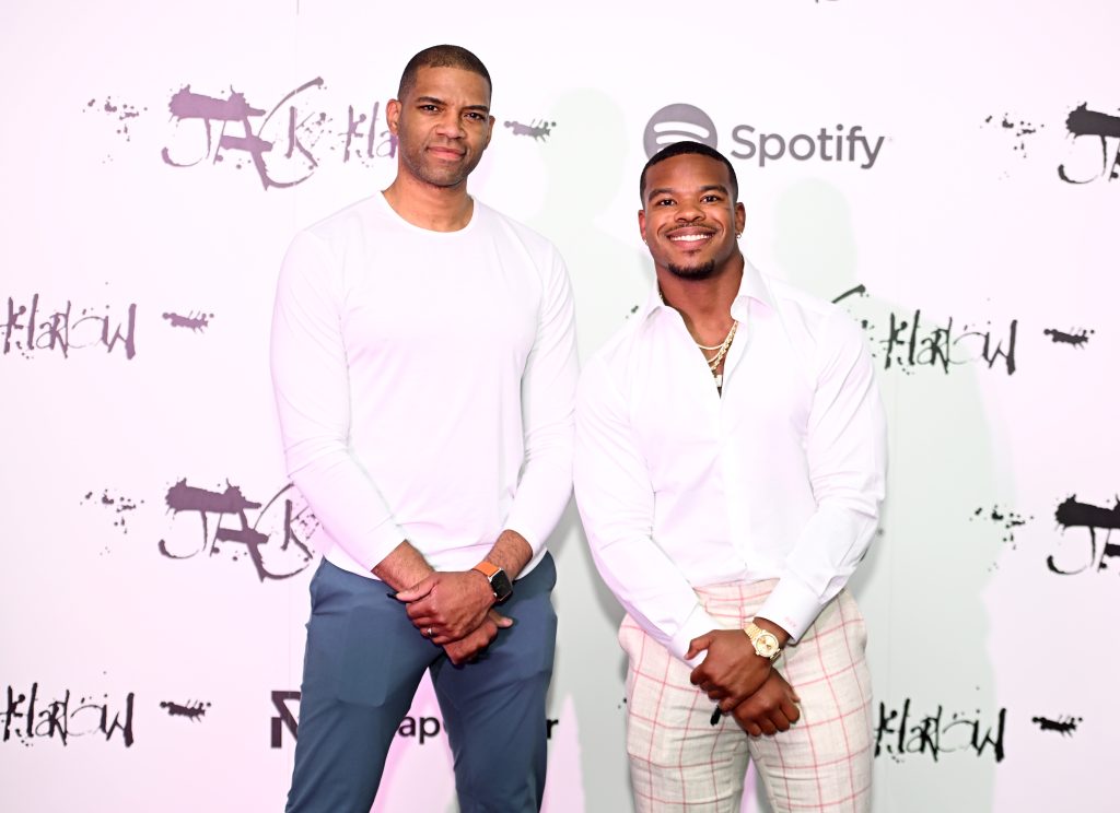 Ron Brown and Damien Harris posing in front of a Spotify x Rap Caviar step-and-repeat.
