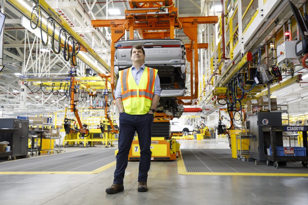 Ford CEO Jim Farley standing in a Ford manufacturing plant