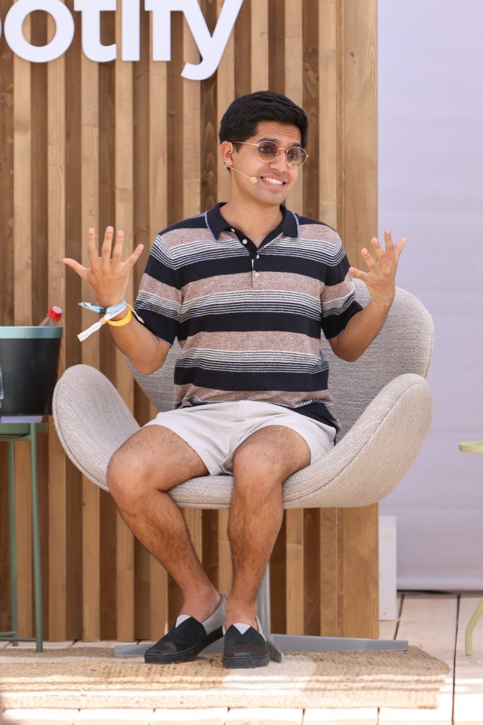 Ziad Ahmen sitting on an outdoor stage for a panell