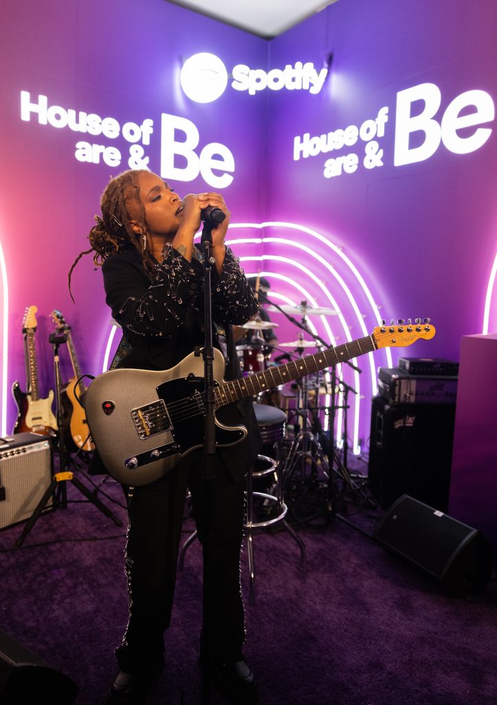 A singer plays guitar and performs on stage