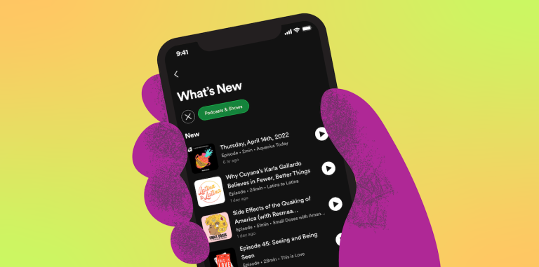 Purple hand holds a phone displaying podcast What's New feed on Spotify